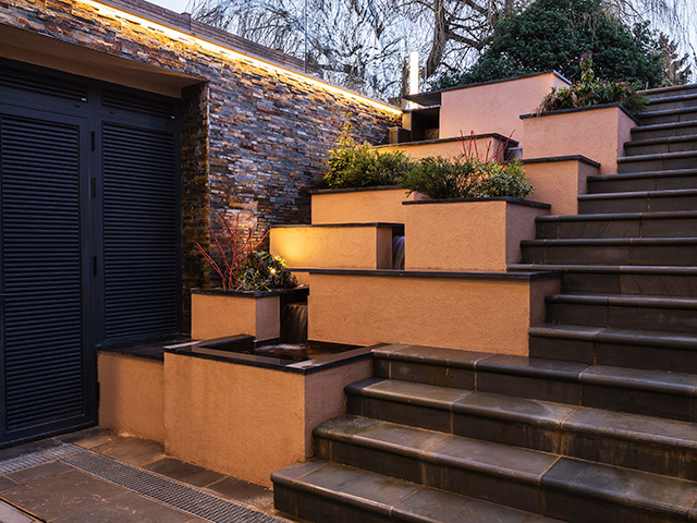 basement steps with planting and water feature - grand designs