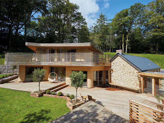 Grand Designs renovations. contemporary home exterior wooden beam balcony