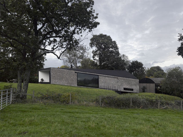 Grand Designs: Living in the country. Stone farm black rubber roof two cocks farm on hillside