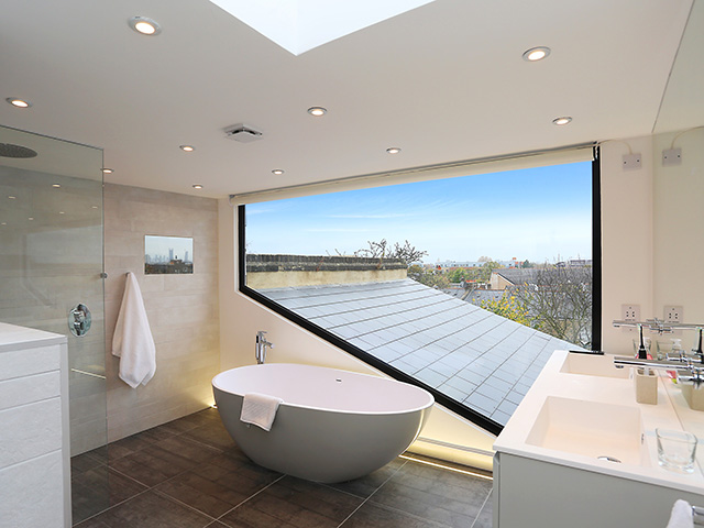 loft conversion bathroom with view over rooftops - grand designs