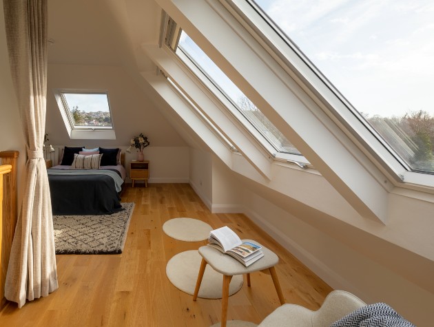 view of bed and windows in converted loft